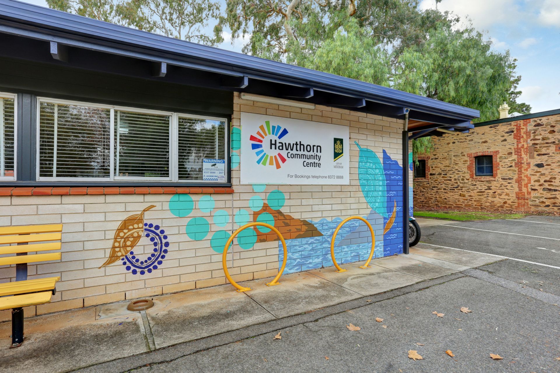A photograph of the indigenous inspired mural on the front corner of the Hawthorn Community Centre created by artists Elizabeth Close and Jake Holmes