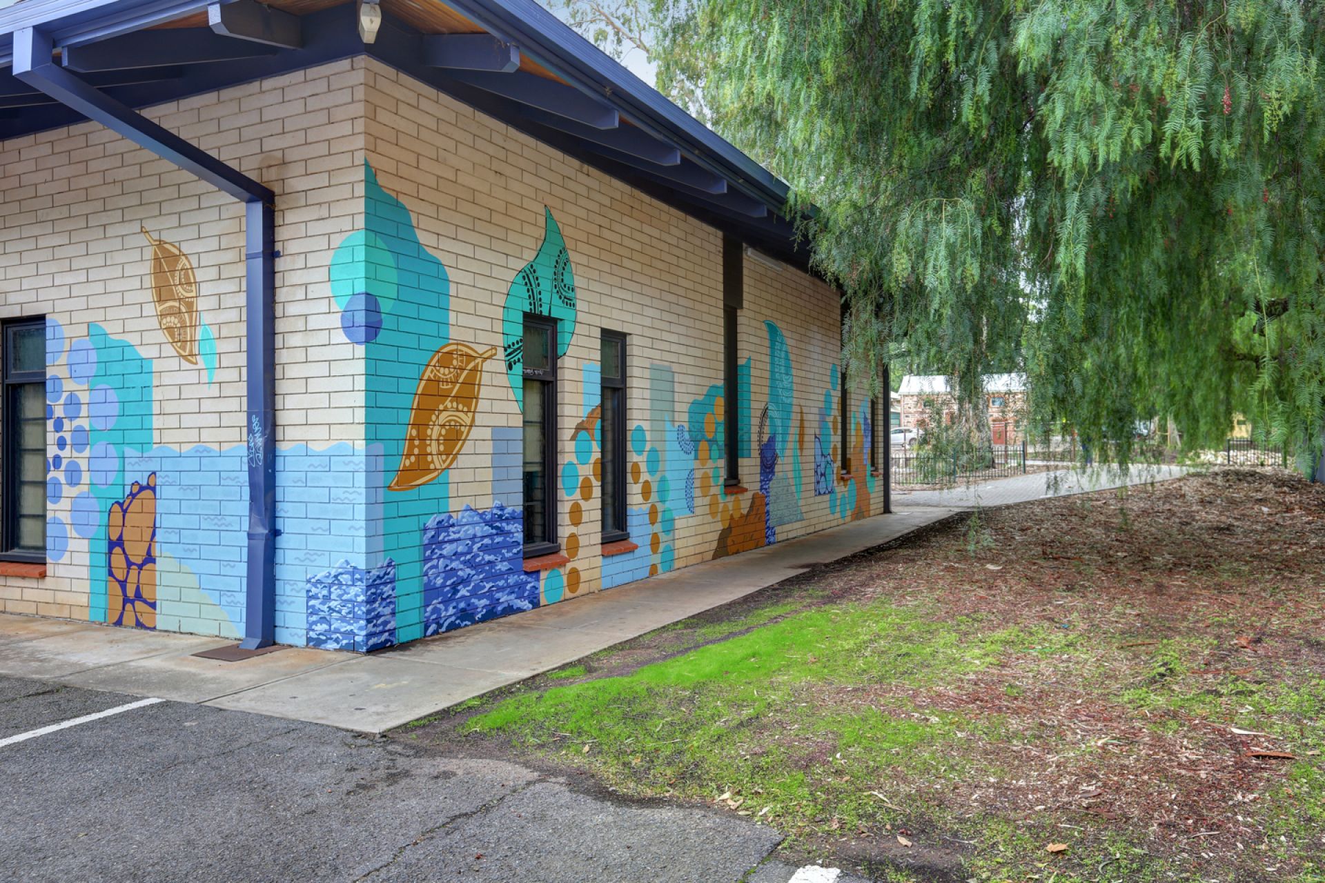 A photograph of the indigenous inspired mural on the side of the Hawthorn Community Centre created by artists Elizabeth Close and Jake Holmes