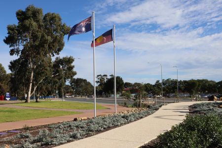 The word ‘Mukapaanthi’, the Kaurna word for ‘remember’, is displayed at the front of the artwork, while Australian and Aboriginal flags have been raised behind the artwork.