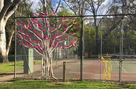 Artist Aiyudot Khom created a tree in blossom to celebrate spring in Four Seasons of Play on the fence at Apex Park