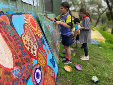 Students from Eden Hills Primary School painting the Grey Box Grassy Woodland Mural