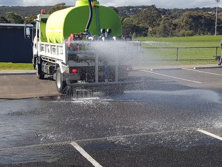 Water being sprayed on the permeable paving at St Marys Park by a water truck