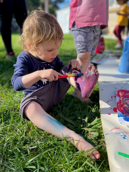 A child painting their foot during messy playtime at Pasadena Community Centre