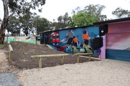 West wall – facing Sturt Lions Football Club The west-facing wall highlights community and connection, with references to the local Scouts and Rotary groups, the iconic hills train line and local sporting soccer club.