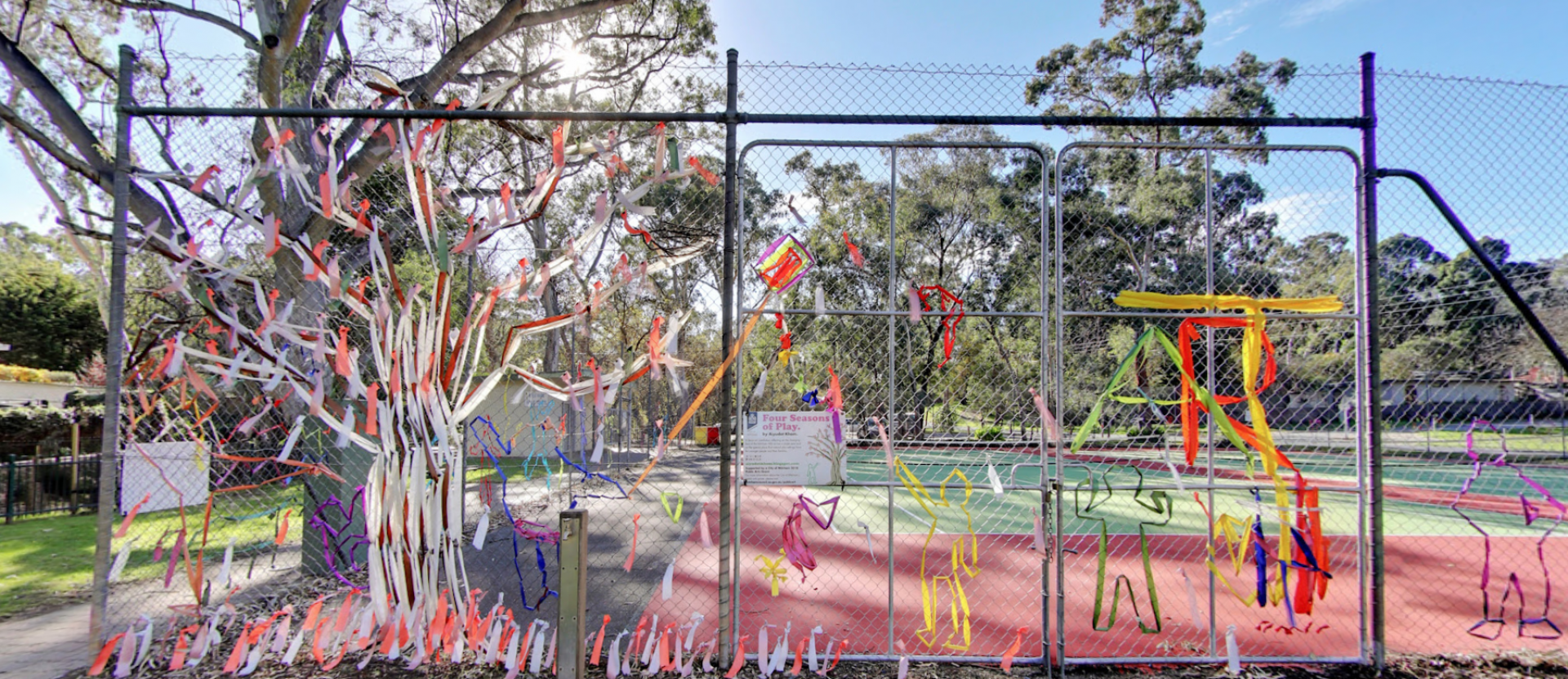 Artist Aiyudot Khom created a tree loosing its leaves in autumn to celebrate spring in Four Seasons of Play on the fence at Apex Park