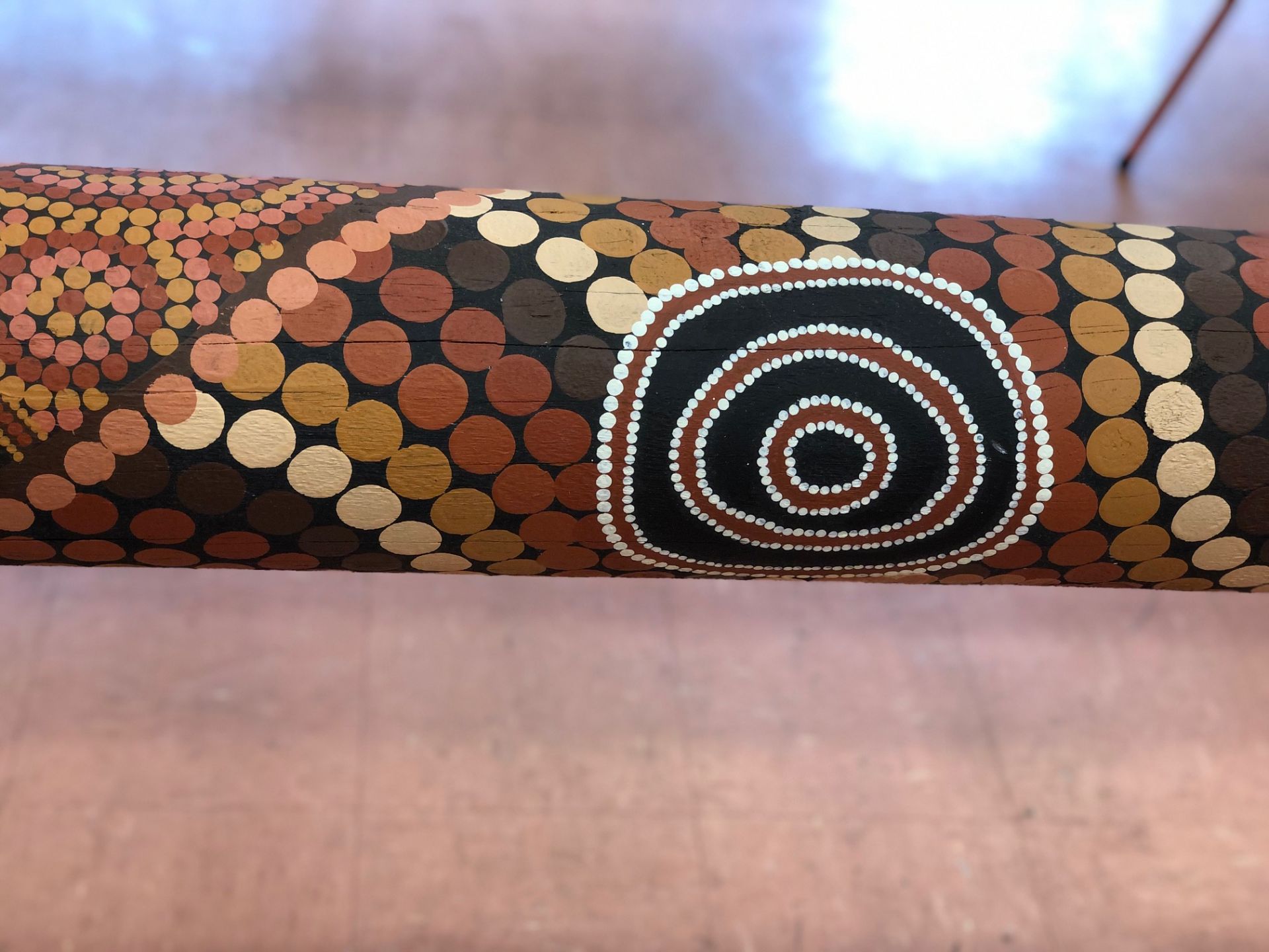 A close up of the Spiritual Grounding Marra Dreaming artwork on the pole
