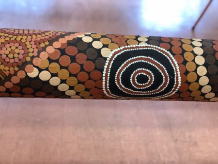 A close up of the Spiritual Grounding Marra Dreaming artwork on the pole